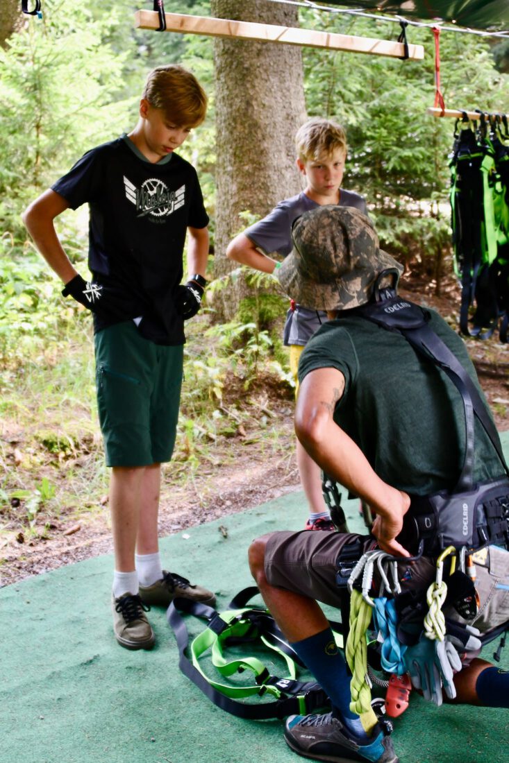 Flo und Ben legen das Klettergeschirr an